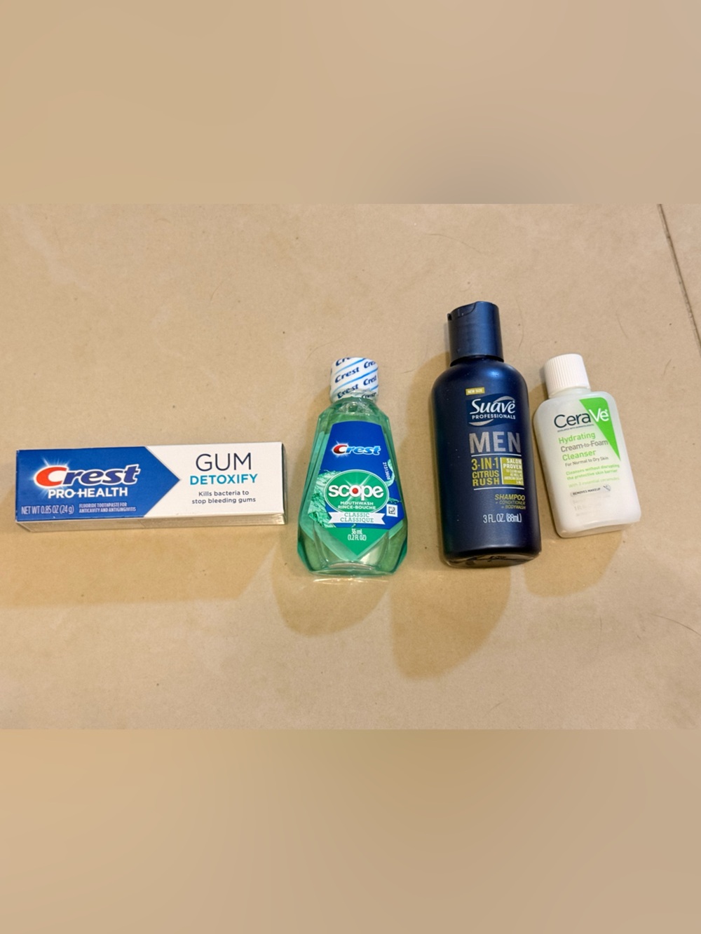 Travel size toothpaste, mouthwash, cerave hydrating cream and suave shampoo